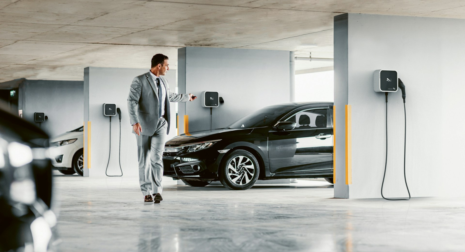 a man in a suit walking in a parking garage